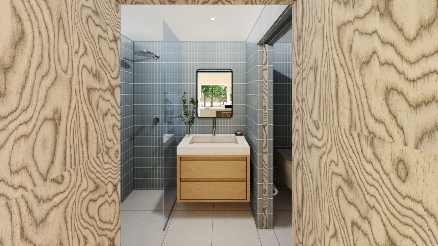 Bathroom with pale blue tile, a walk-in shower, and a wood vanity