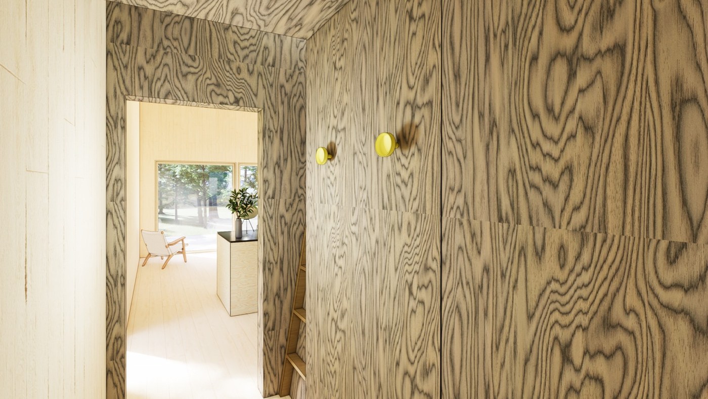 Entry hall lined in dark woodgrain panels with yellow coat hooks, opening to the bright main room