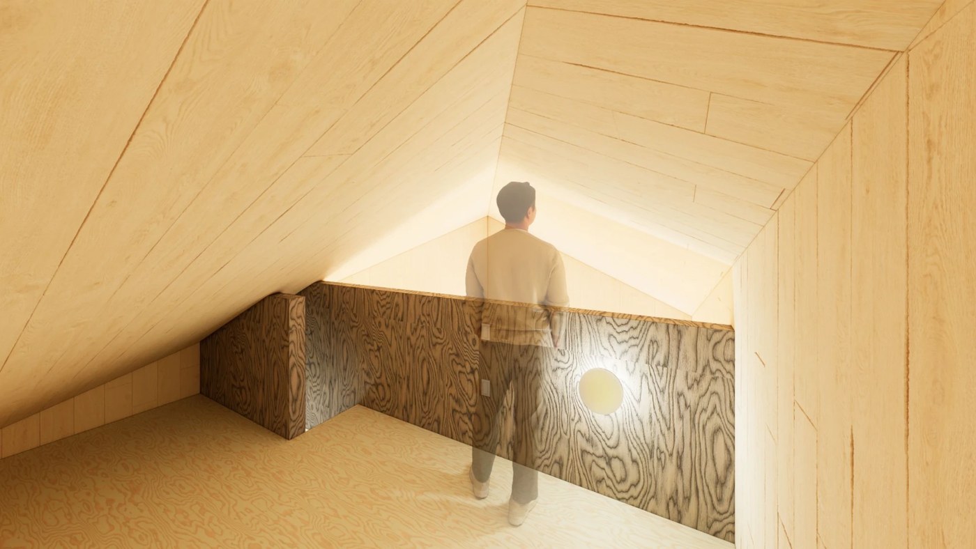 Sleeping loft tucked under the roofline, warm light washing the peak of the ceiling