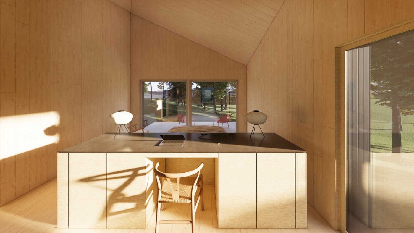 Utility island with a built-in desk and chair facing the bedroom windows