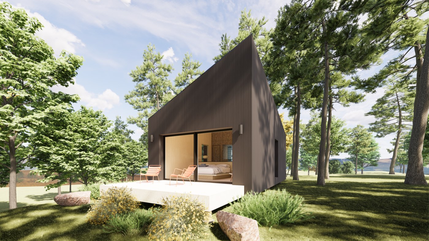 A dark modern cabin with a white deck among pines outside Salida, Colorado